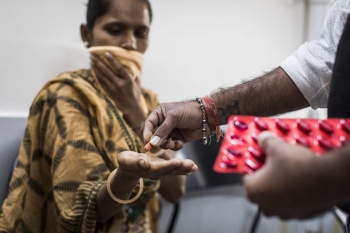 Narishaben receiving DOT program medication from Mikesh Vanuzu at the Hirabaug Health Centre, Surat.